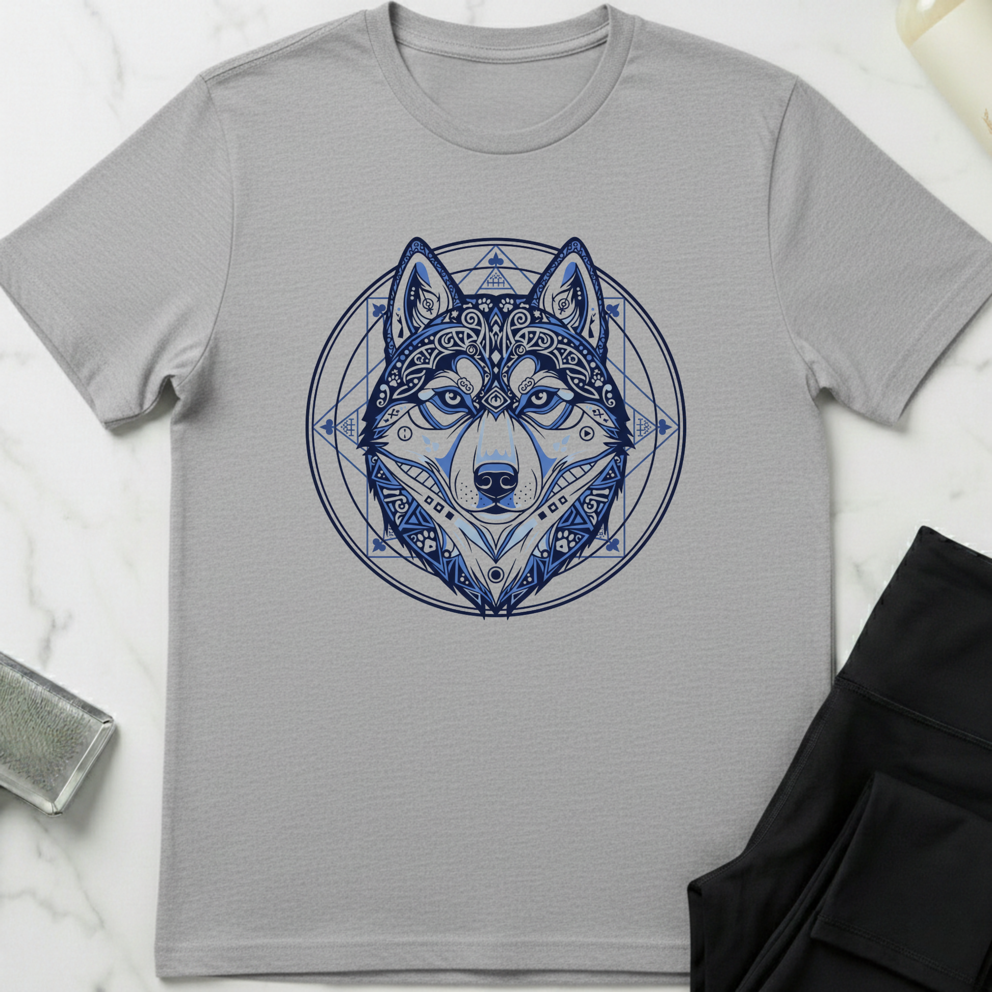 Gray t-shirt with a blue husky design on a white marble surface. Minimalist dog apparel by pemuyo.
