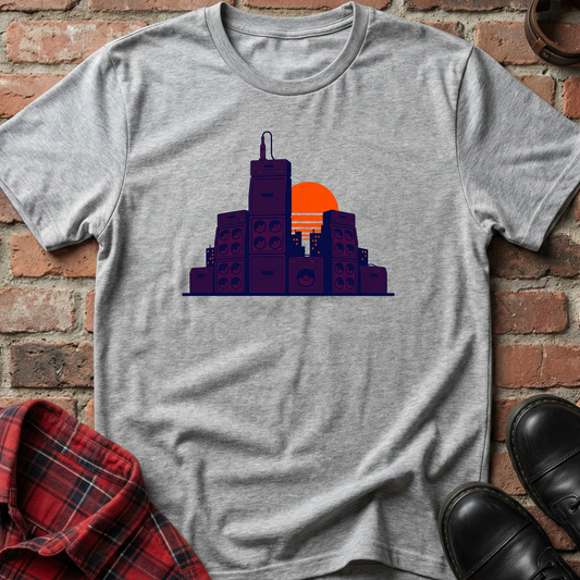 Gray t-shirt with cityscape design on a brick wall background. Minimalist music apparel by pemuyo.