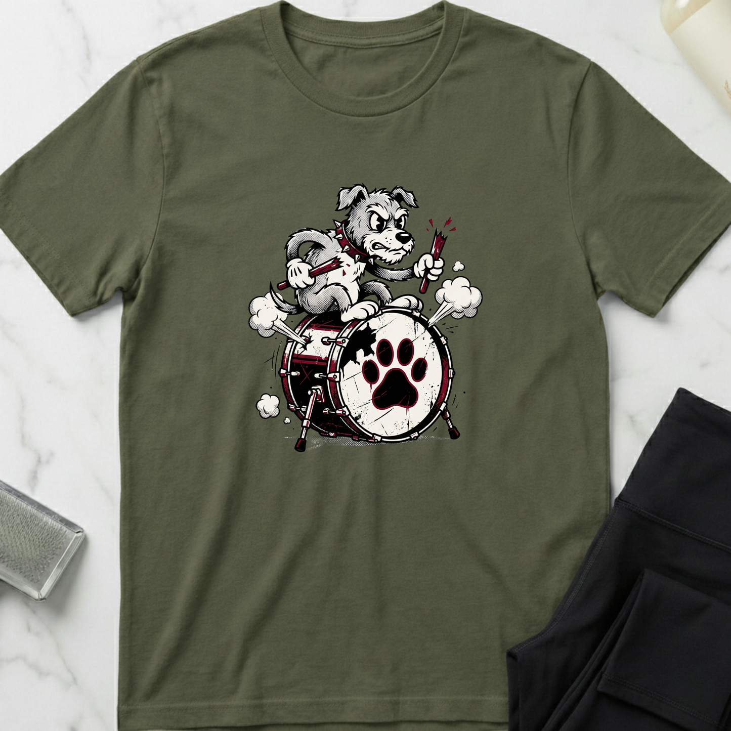 Green t-shirt with a graphic of a dog playing drums on a white marble surface. Minimalist dog apparel by pemuyo.