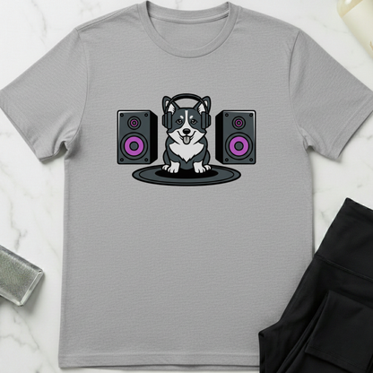 Gray t-shirt with a dog wearing headphones and speakers design on a white marble surface. Minimalist dog apparel by pemuyo.