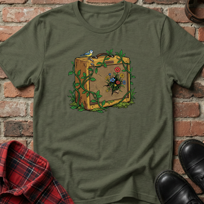 Green t-shirt with a suitcase and nature-themed design on a brick background. Minimalist music apparel by pemuyo.