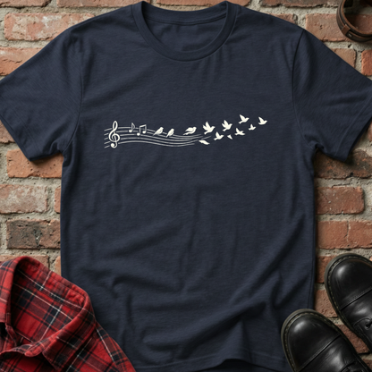 Navy blue t-shirt with musical note and bird design on a brick background. Minimalist music apparel by pemuyo.