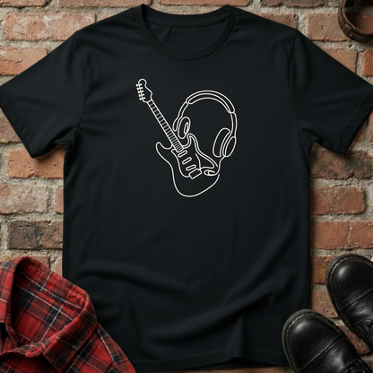 Black t-shirt with a white graphic design of a guitar and headphones on a brick background. Minimalist music apparel by pemuyo.