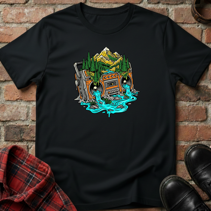 Black t-shirt with a graphic design of a mountain and cassette tape on a brick wall background. Minimalist music apparel by pemuyo.