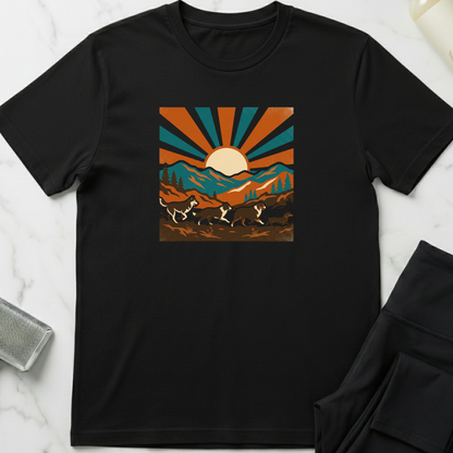 Black t-shirt with a graphic design of mountains and a sun on a white marble surface. Minimalist dog apparel by pemuyo.
