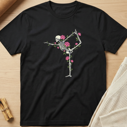 Black t-shirt with a skeleton and floral design on a wooden surface. Minimalist yoga apparel by pemuyo.
