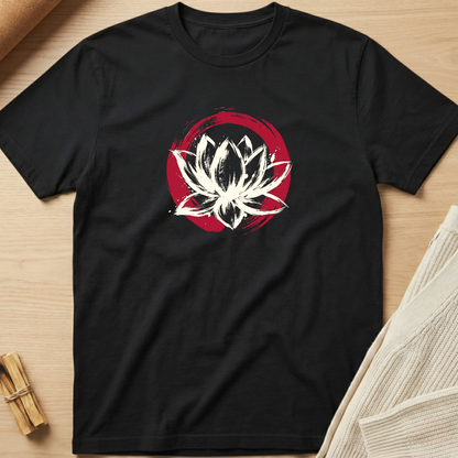 Black t-shirt with a white lotus flower design on a wooden surface. Minimalist yoga apparel by pemuyo.