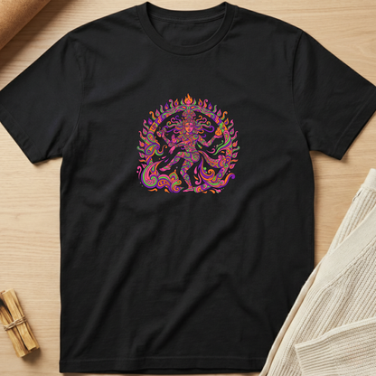 A black short-sleeve crewneck t-shirt laid flat on a light wood surface, featuring a colorful graphic of a dancing Hindu deity in the center. The graphic contains a mix of pink, purple, orange, and green tones. Minimalist yoga apparel by pemuyo.