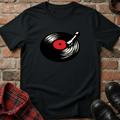 Black t-shirt with a vinyl record design on a brick background. Minimalist music apparel by pemuyo.