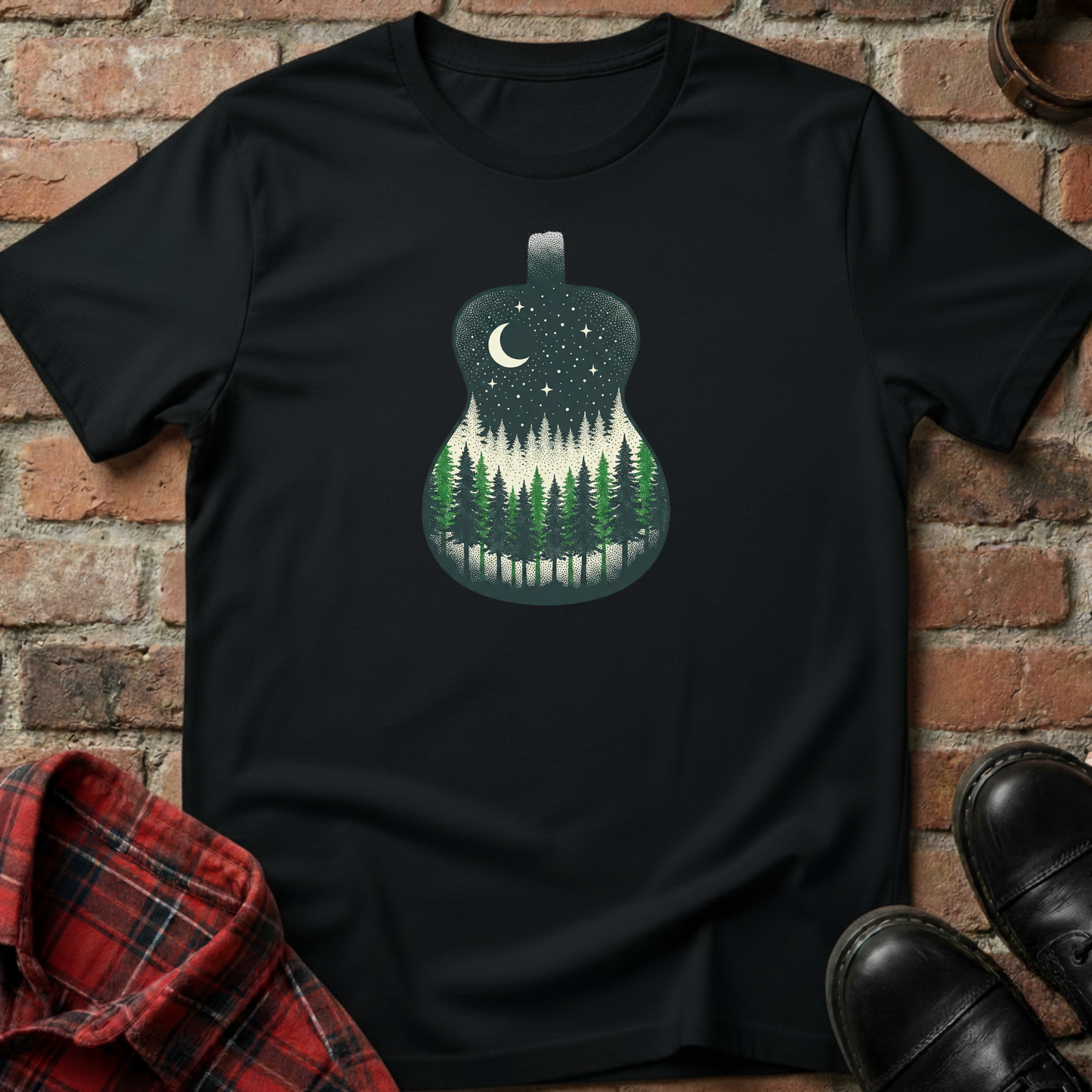 Black t-shirt with a forest design in a guitar shape against a brick wall. Minimalist music apparel by pemuyo.
