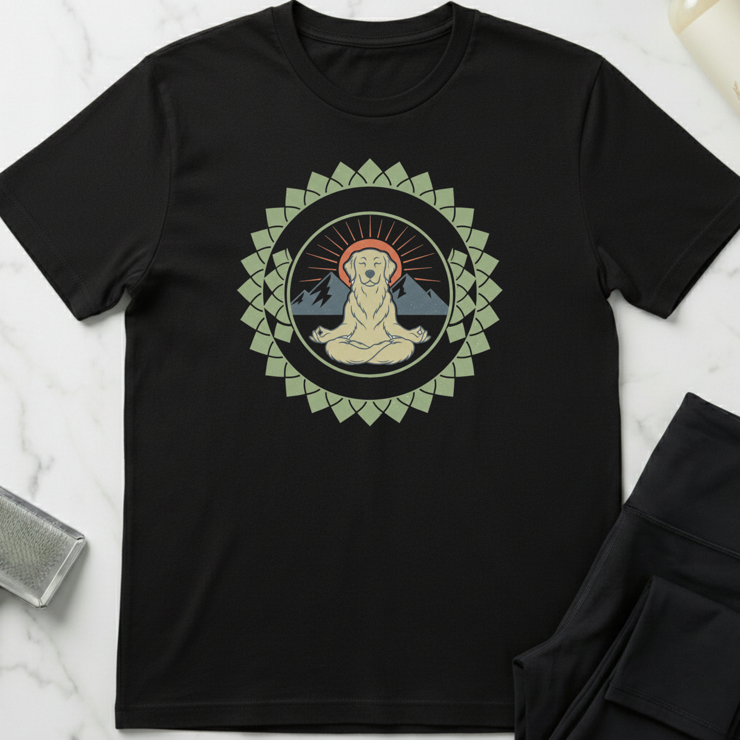 Black t-shirt with a meditating Buddha graphic on a white marble surface. Minimalist yoga apparel by pemuyo.