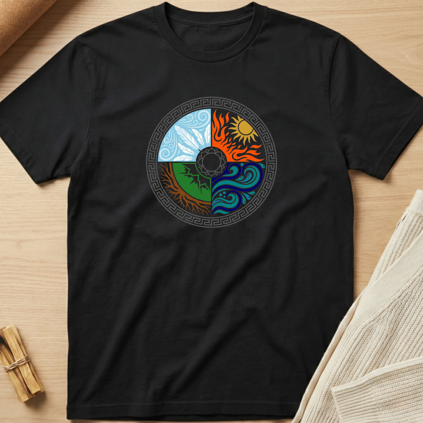 Black t-shirt with a colorful circular design on a wooden surface. Minimalist yoga apparel by pemuyo.