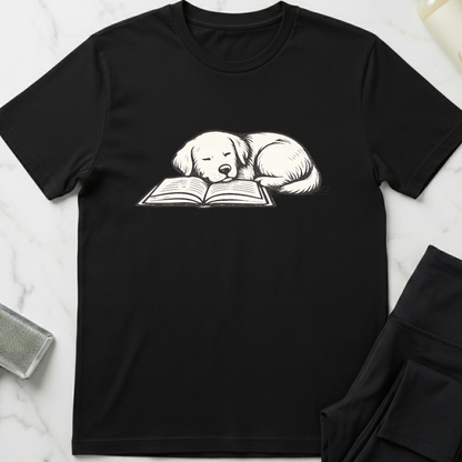 Black t-shirt with a graphic of a dog reading a book on a marble surface. Minimalist dog apparel by pemuyo.