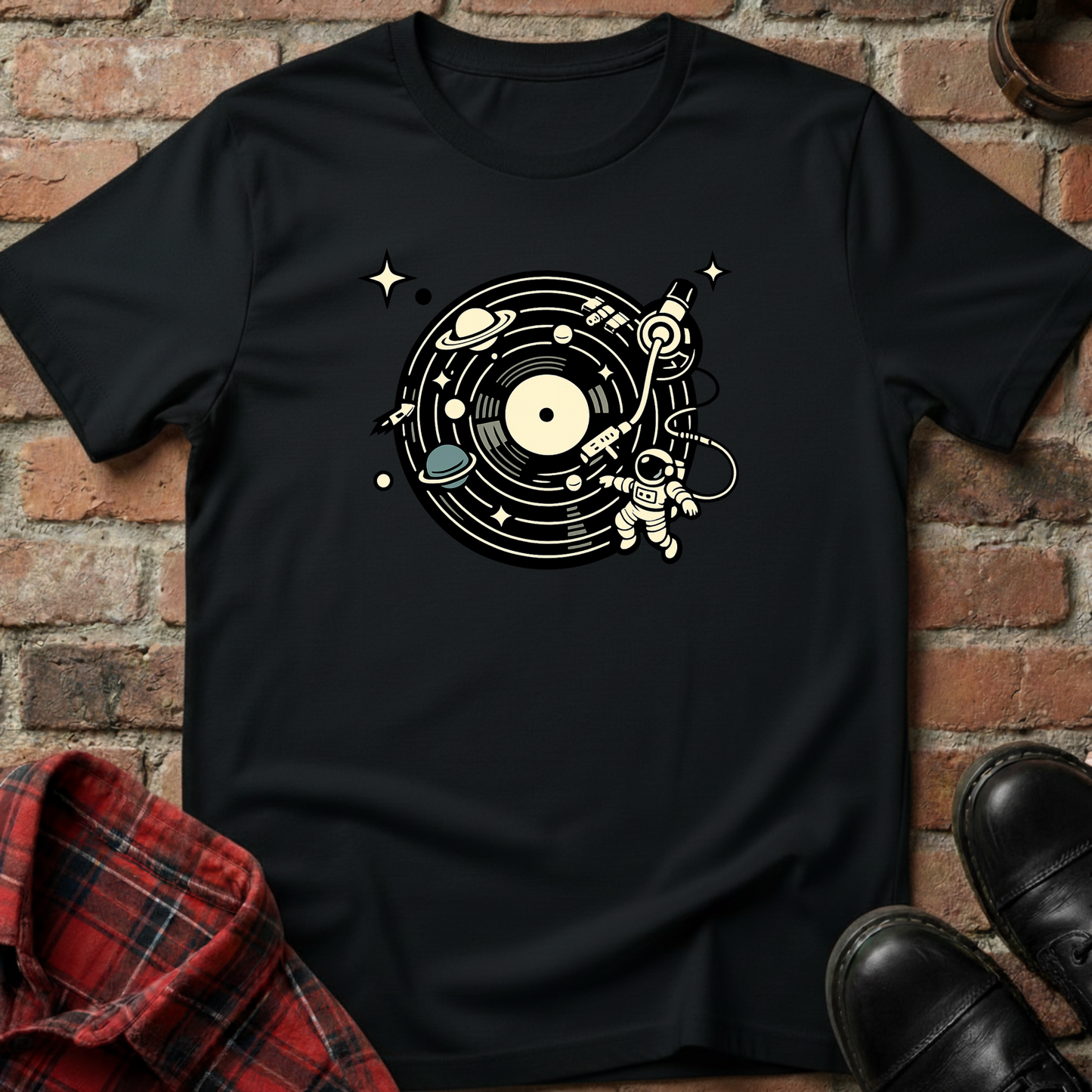 Black t-shirt with space-themed design on a brick wall background. Minimalist music apparel by pemuyo.