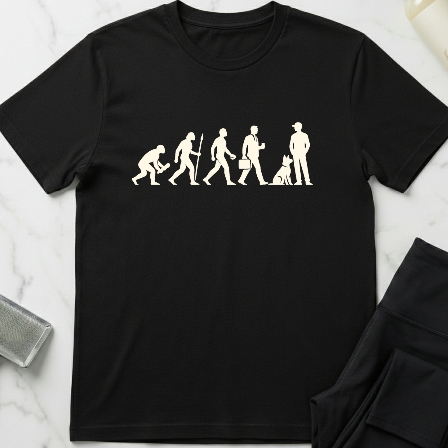 Black t-shirt with white graphic design on a marble surface. Minimalist dog apparel by pemuyo.