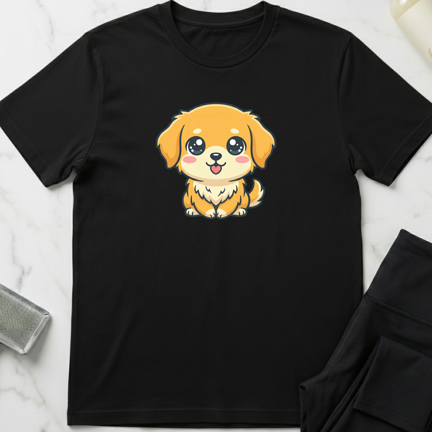 Black t-shirt with a cartoon dog design on a white marble surface. Minimalist dog apparel by pemuyo.