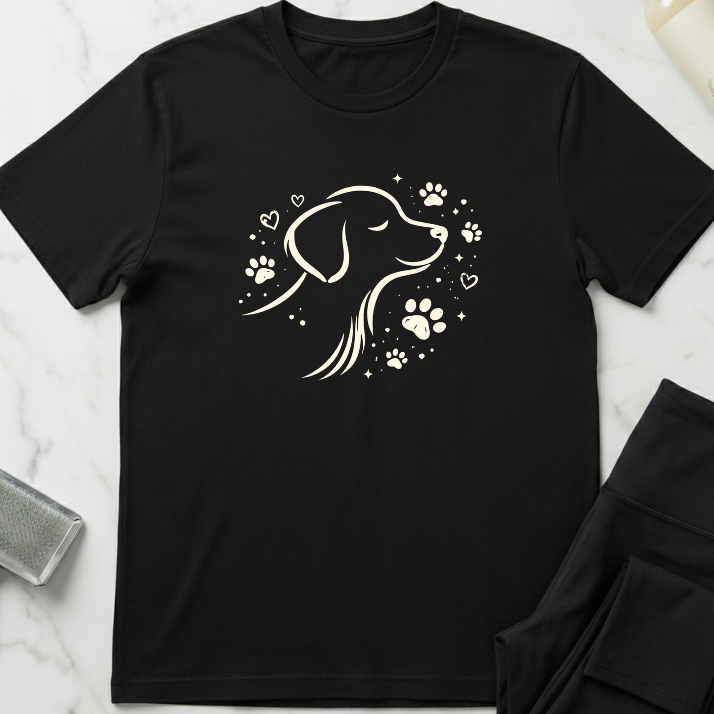 Black t-shirt with a dog wearing headphones and speakers design on a marble surface. Minimalist dog apparel by pemuyo.