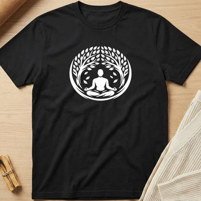 Black t-shirt with a white meditation design on a wooden surface. Minimalist yoga apparel by pemuyo.