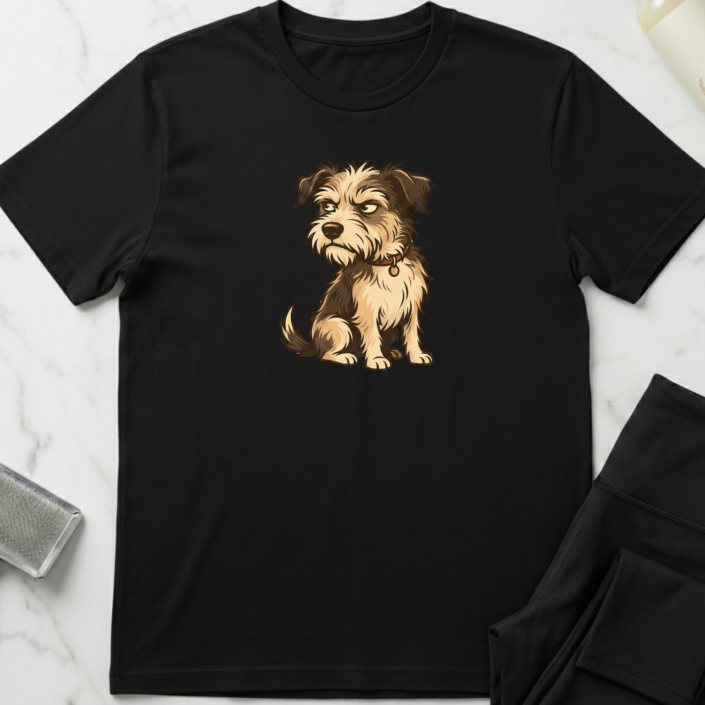 Black t-shirt with a dog graphic on a marble surface. Minimalist dog apparel by pemuyo.