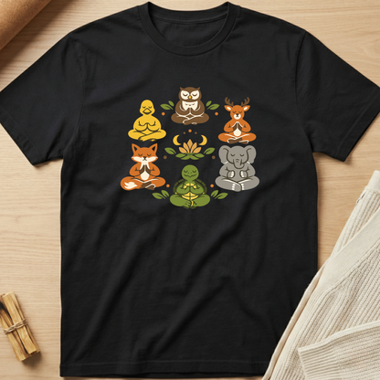 Black t-shirt with animal illustrations in a meditative pose on a wooden surface. Minimalist yoga apparel by pemuyo.