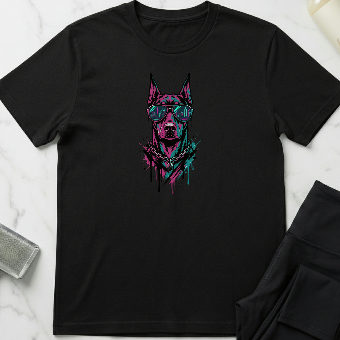 Black t-shirt with a dog graphic design on a marble surface. Minimalist dog apparel by pemuyo.