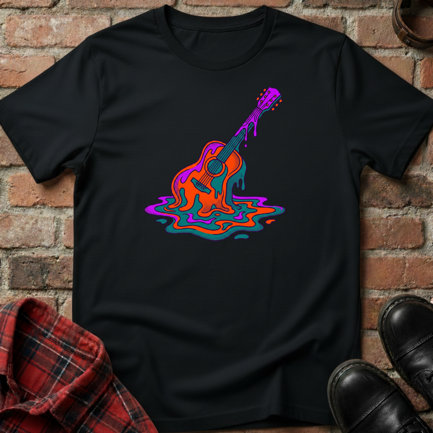 Black t-shirt with colorful guitar design on a brick wall background. Minimalist music apparel by pemuyo.