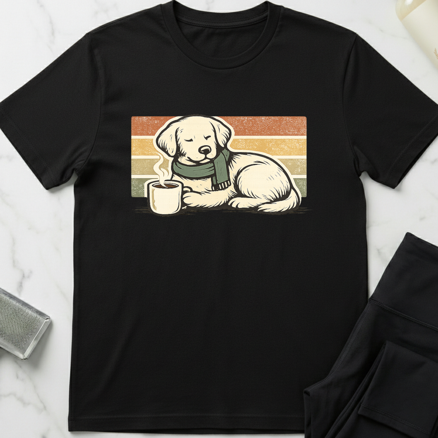 Black t-shirt with a graphic of a dog wearing a scarf and holding a mug on a white marble surface. Minimalist dog apparel by pemuyo.