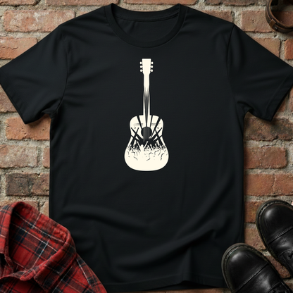 Black t-shirt with a white guitar graphic on a brick background. Minimalist music apparel by pemuyo.