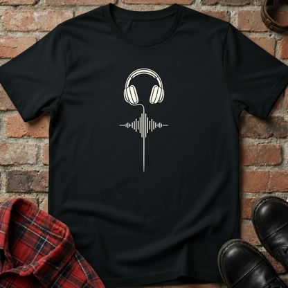 Black t-shirt with white headphone design on a brick background. Minimalist music apparel by pemuyo.