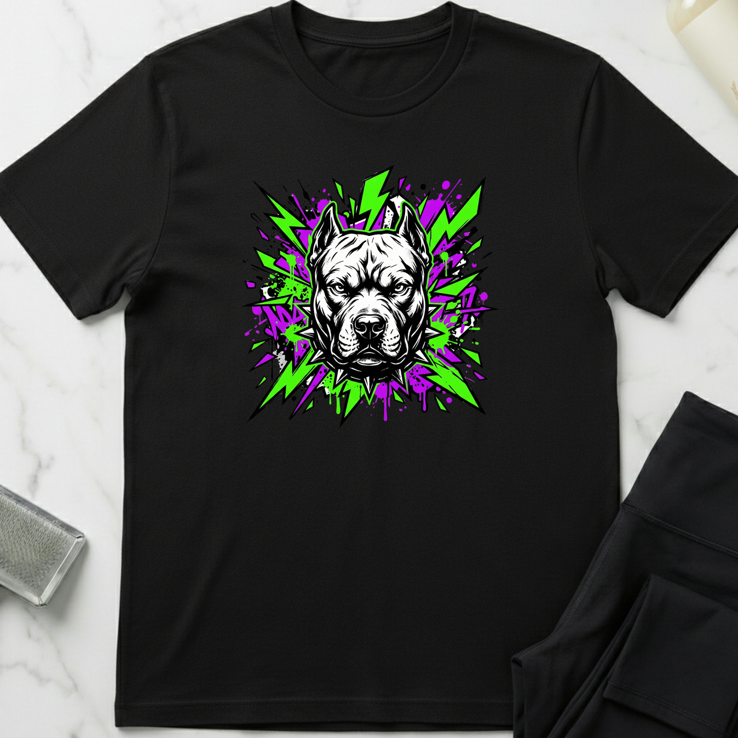 Black t-shirt with a dog graphic design on a marble surface. Minimalist dog apparel by pemuyo.