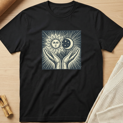 Black t-shirt with a graphic design of hands holding a sun and moon on a wooden surface. Minimalist yoga apparel by pemuyo.