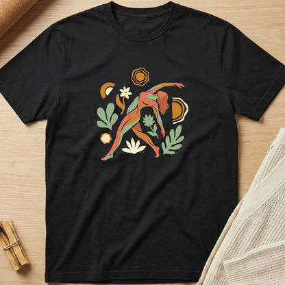 Black t-shirt with a colorful abstract design on a wooden surface. Minimalist yoga apparel by pemuyo.