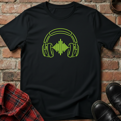 Black t-shirt with green headphone graphic on a brick wall background. Minimalist music apparel by pemuyo.
