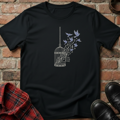 Black t-shirt with a birdcage and flying birds design on a brick background. Minimalist music apparel by pemuyo.