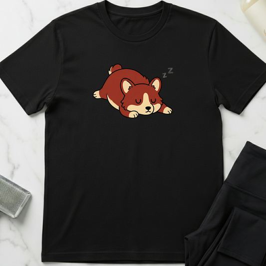Black t-shirt with a cartoon dog design on a marble surface. Minimalist dog apparel by pemuyo.