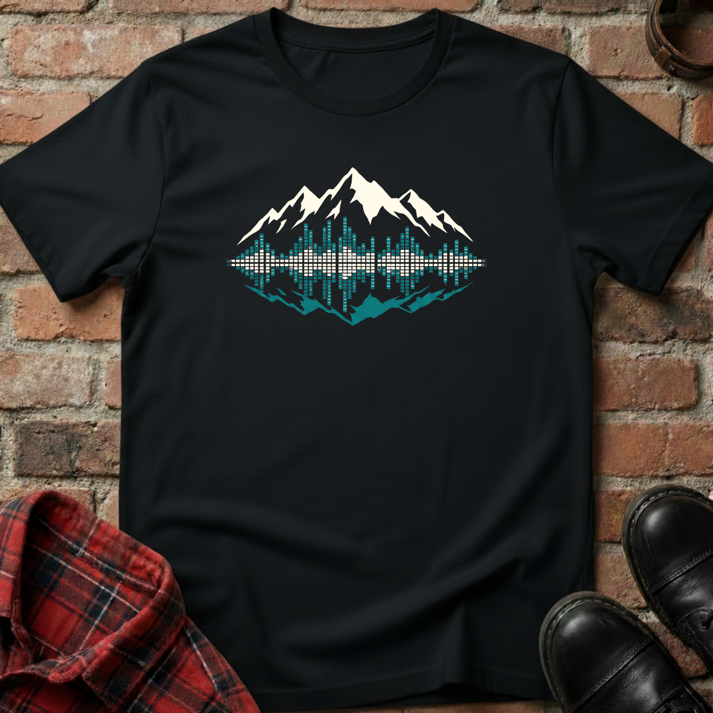 Black t-shirt with mountain graphic design on a brick background. Minimalist music apparel by pemuyo.