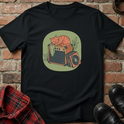 Black t-shirt with a graphic of a cat on an amplifier against a brick wall. Minimalist music apparel by pemuyo.