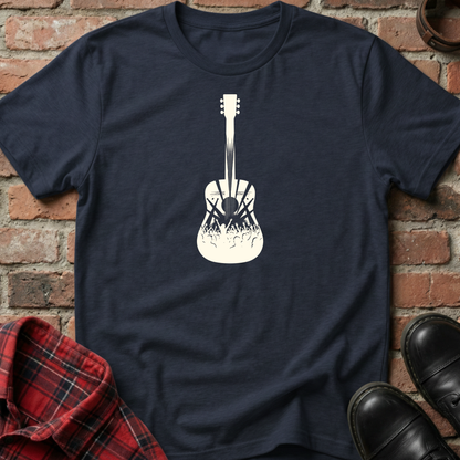 Navy blue t-shirt with white guitar graphic on a brick wall background. Minimalist music apparel by pemuyo.
