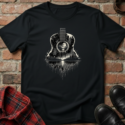 Black t-shirt with guitar graphic on a brick wall background. Minimalist music apparel by pemuyo.
