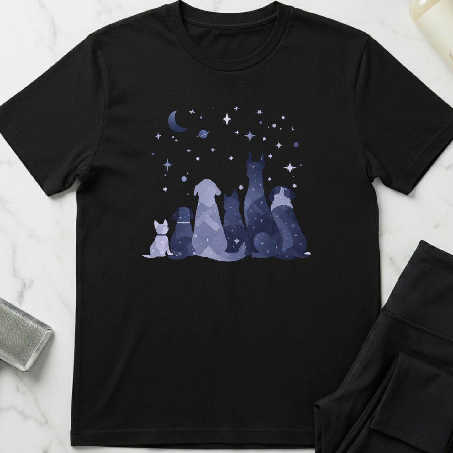 Black t-shirt with a graphic of dogs under a moon and stars on a marble surface. Minimalist dog apparel by pemuyo.