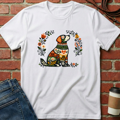 White t-shirt with a colorful dog design on a brick wall background. Minimalist dog apparel by pemuyo.