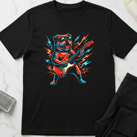 Black t-shirt with a colorful dog playing guitar graphic on a white marble surface. Minimalist dog apparel by pemuyo.