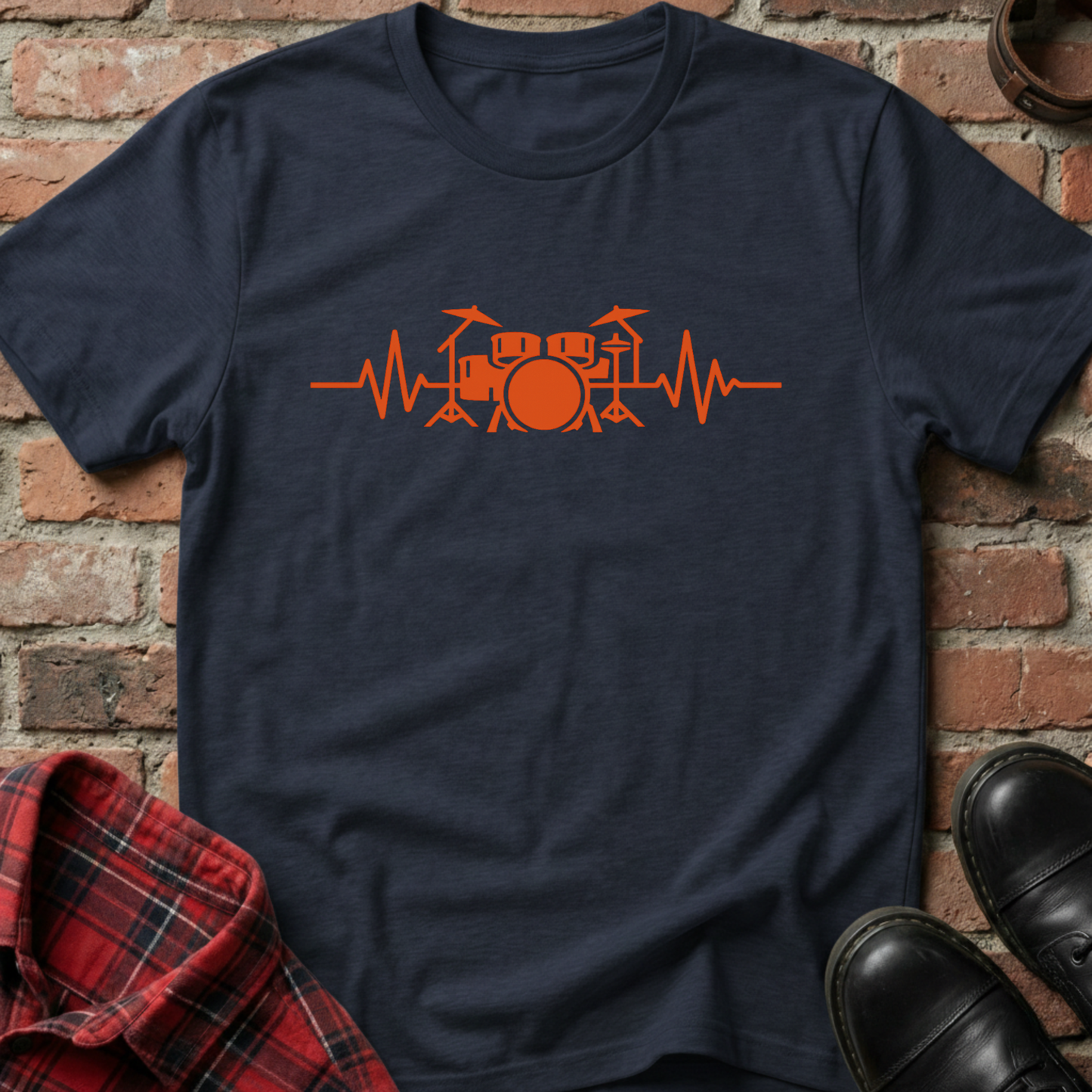 Navy blue t-shirt with orange drum set design on a brick background. Minimalist music apparel by pemuyo.
