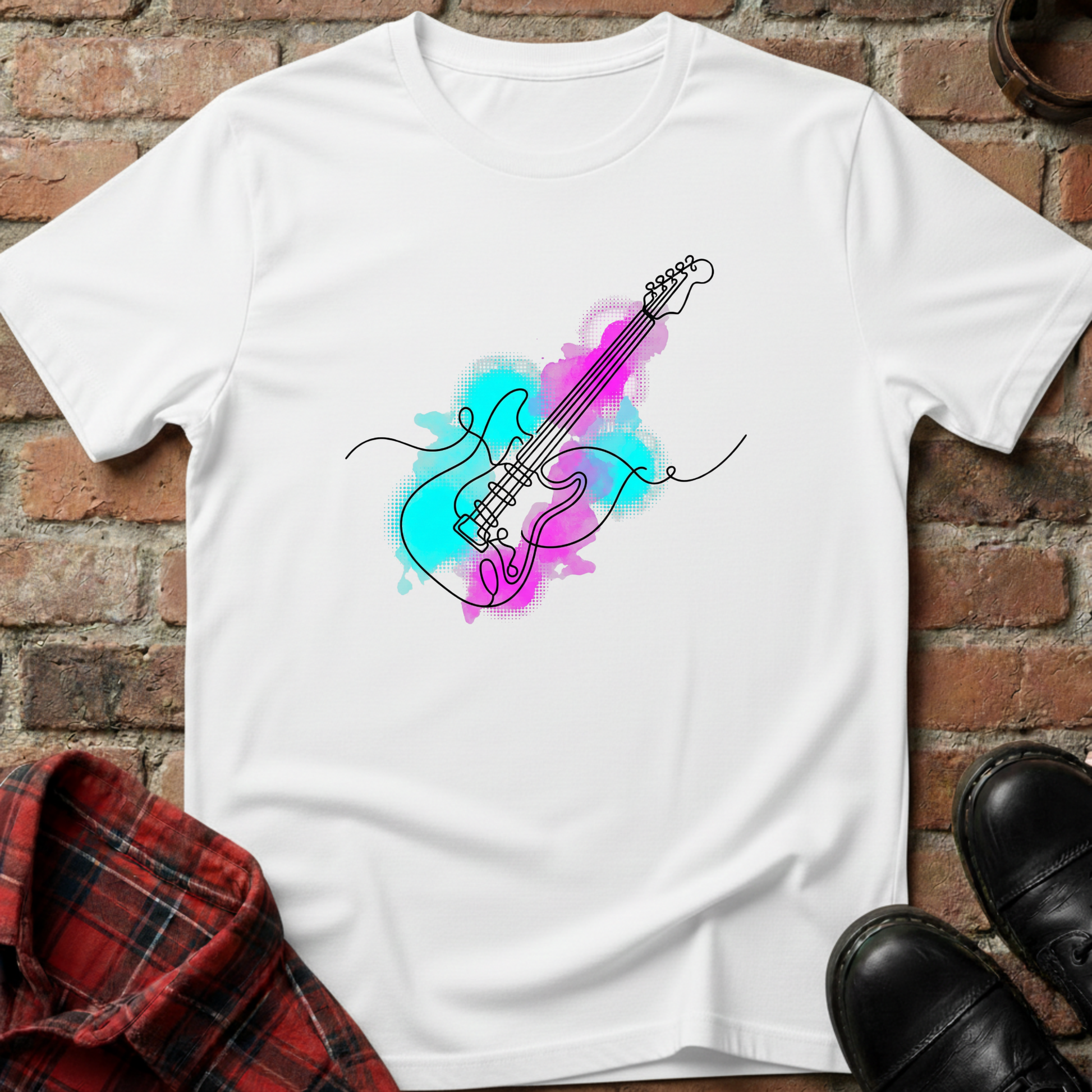 White t-shirt with colorful guitar design on a brick surface. Minimalist music apparel by pemuyo.