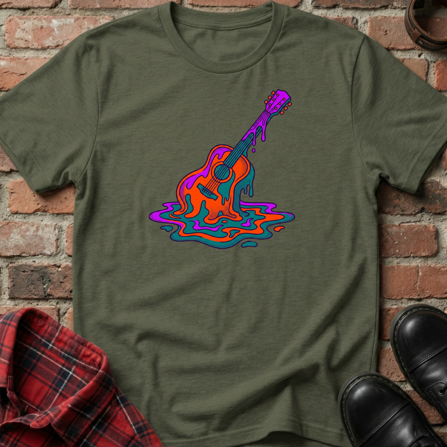 Green t-shirt with a colorful guitar design on a brick background. Minimalist music apparel by pemuyo.