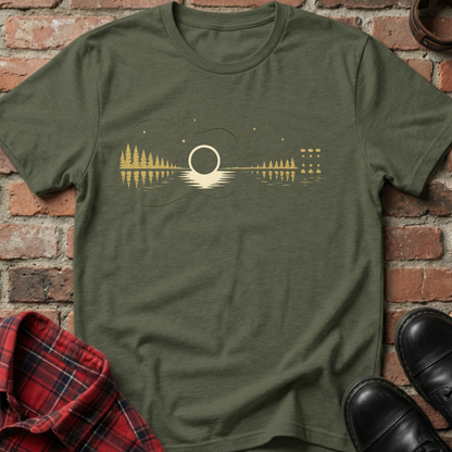 Green t-shirt with a nature-themed design on a brick surface. Minimalist music apparel by pemuyo.