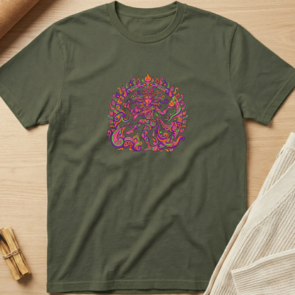 An olive green crewneck t-shirt featuring a colorful, vibrant mandala-style graphic of a dancing figure on the chest, presented flat on a light wood background with styled props. Minimalist yoga apparel by pemuyo.