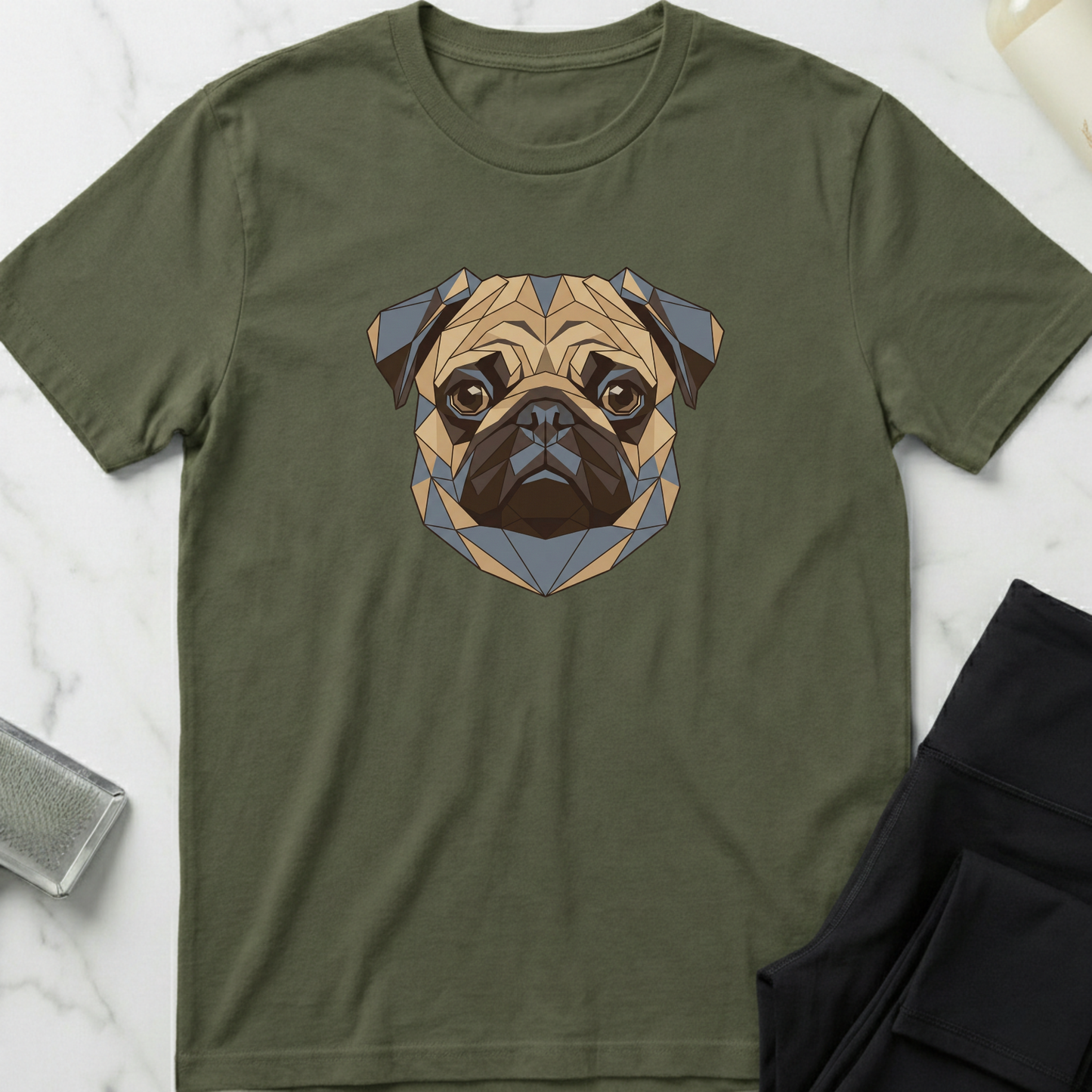 Green t-shirt with a geometric pug design on a marble surface. Minimalist dog apparel by pemuyo.