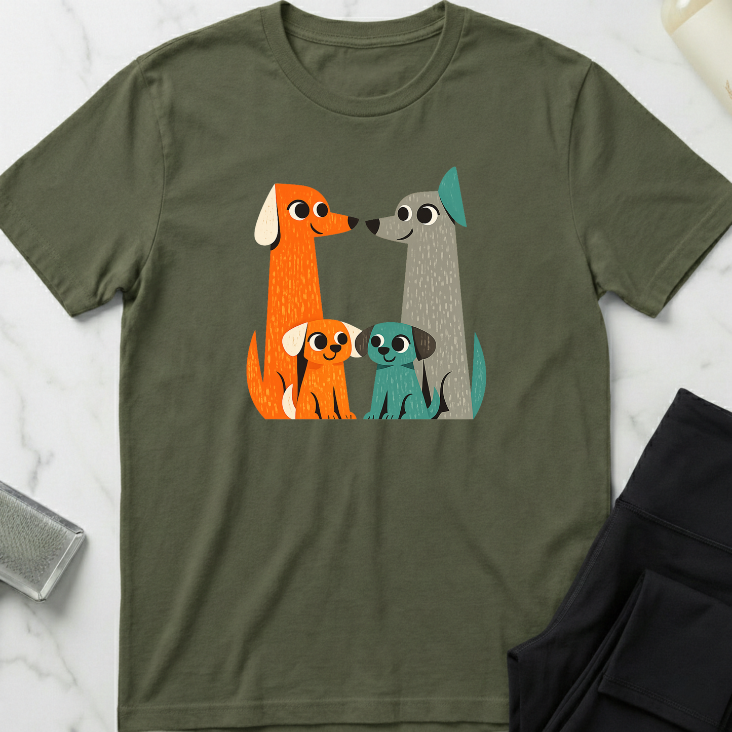 Green t-shirt with cartoon dog family design on a marble surface. Minimalist dog apparel by pemuyo.