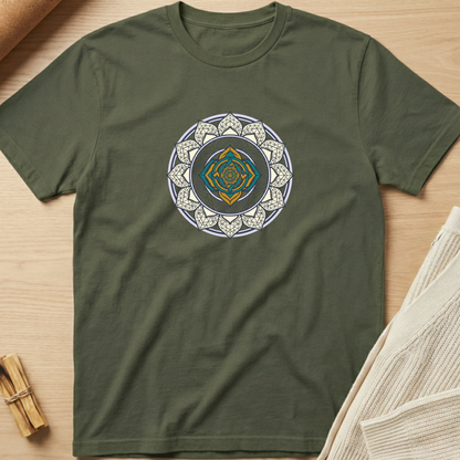 Green t-shirt with a white geometric design on a wooden surface. Minimalist yoga apparel by pemuyo.